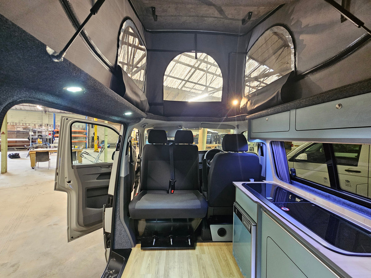 Relive campervan interior with fitted kitchen and seating