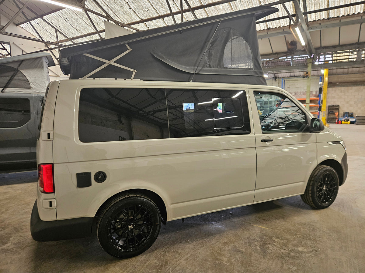 Campervan with raised pop-top roof at the Relive workshop