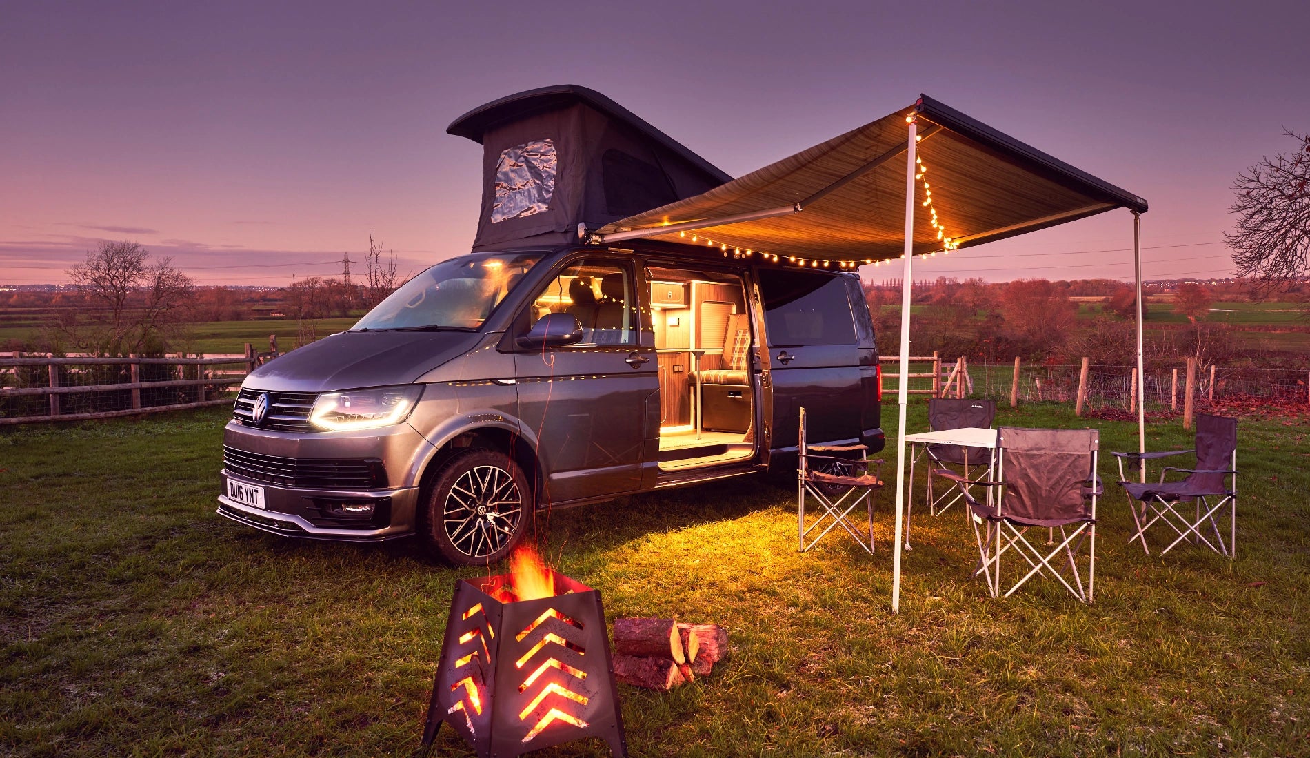 Grey Volkswagen campervan pop top with awning