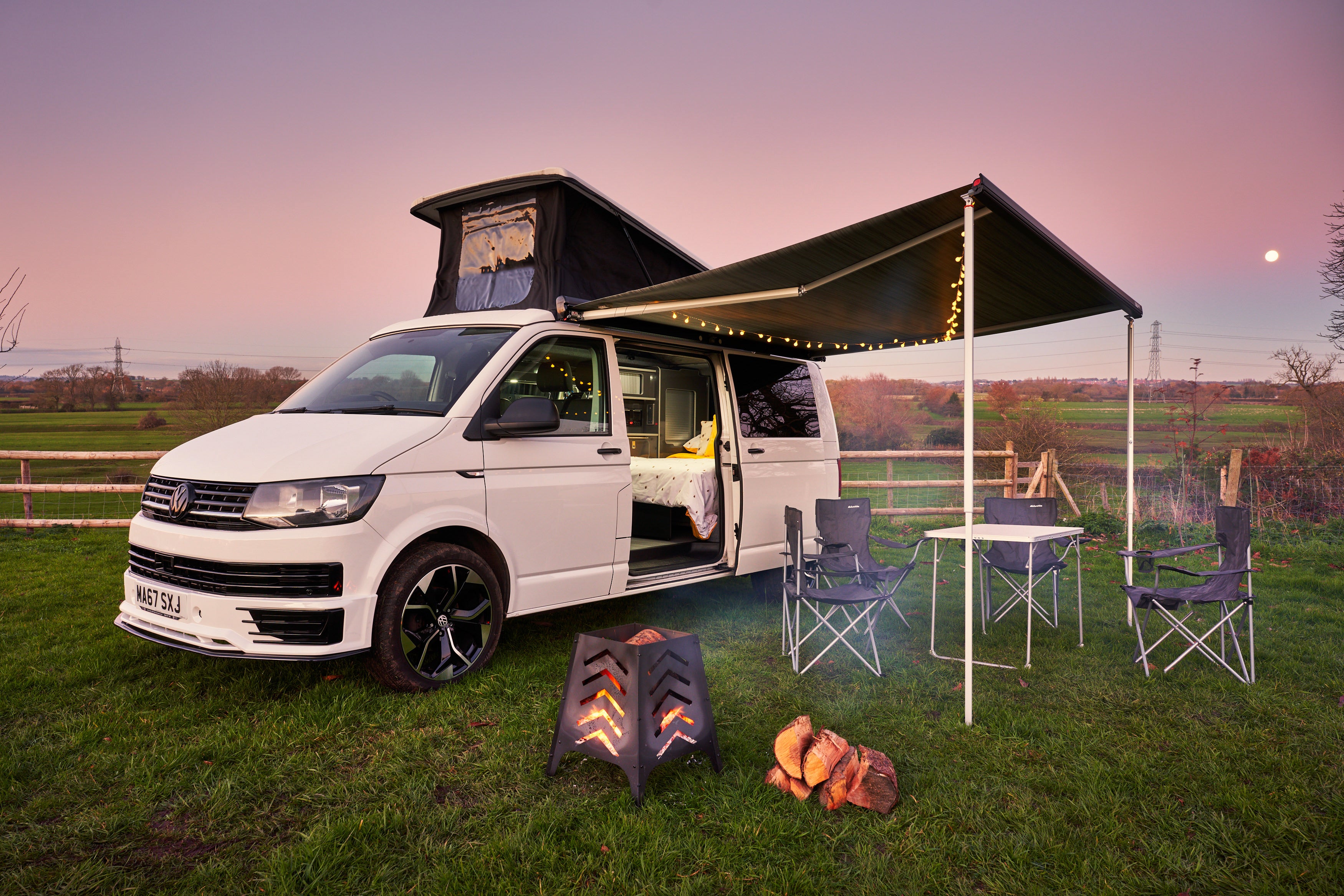 White Volkswagen campervan with awning