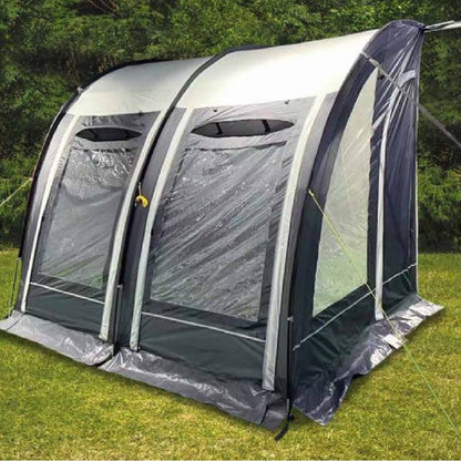 Inflatable campervan awning with clear windows set up on green grass outdoors