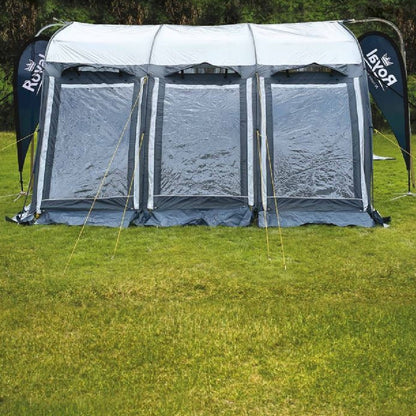 Large campervan driveway awning tent with clear windows set up on grassy field