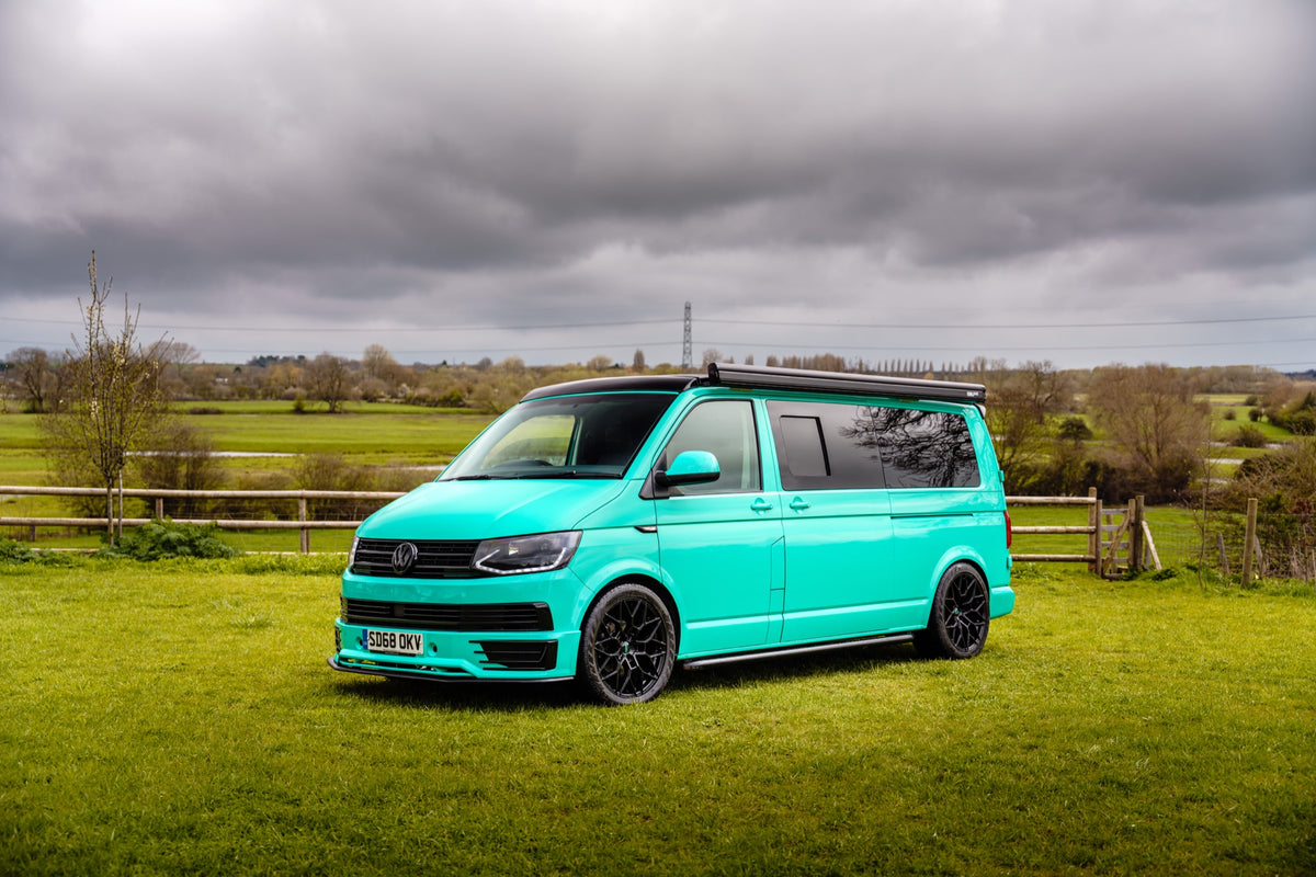 Completed turquoise campervan photographed outdoors