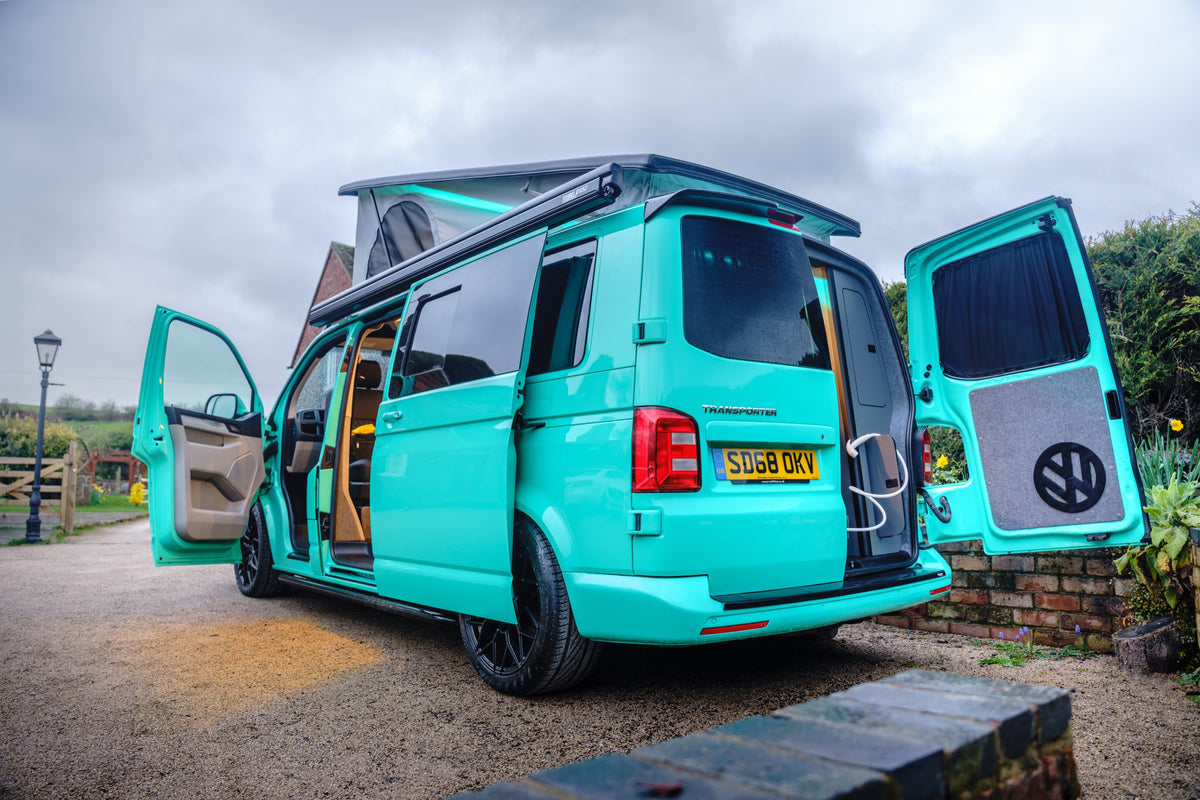 Turquoise Relive campervan with doors open and pop-top roof raised