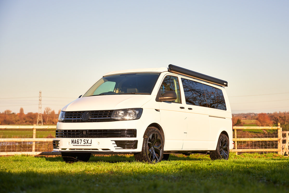 White Relive campervan with side awning parked outdoors