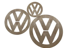 Three wooden Volkswagen logos on a white background cut on a CNC machine made from plywood